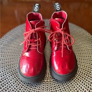 TODDLER RED PATENT COMBAT BOOTS. “LOVE” PRINTED ON BACK PULL TABS.
